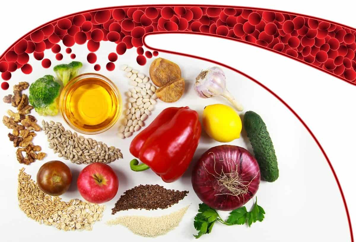 Illustration of red blood cells in a vessel above vegetables, fruit, nuts, seeds and oil