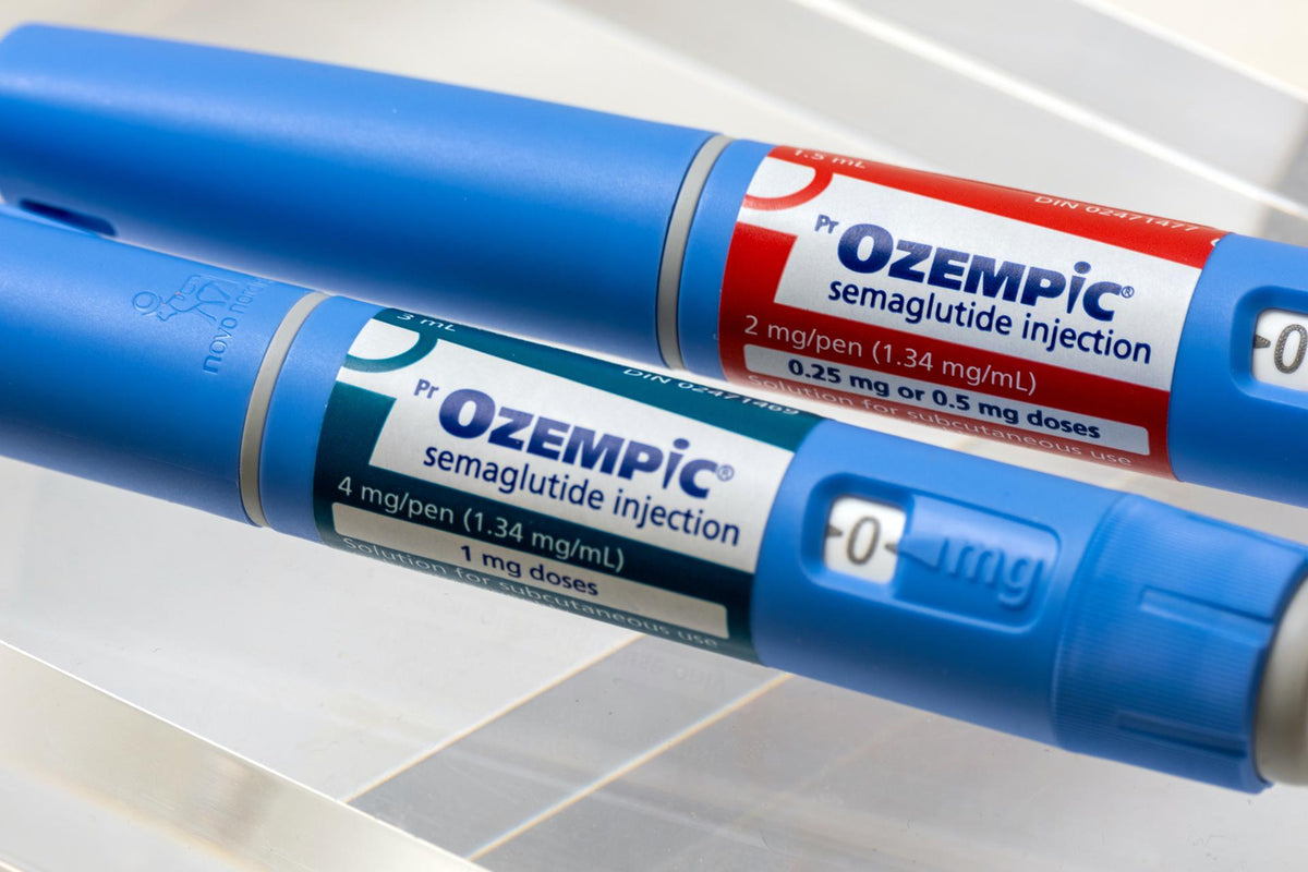 Close-up of two Ozempic semaglutide injection pens with red and blue dose labels