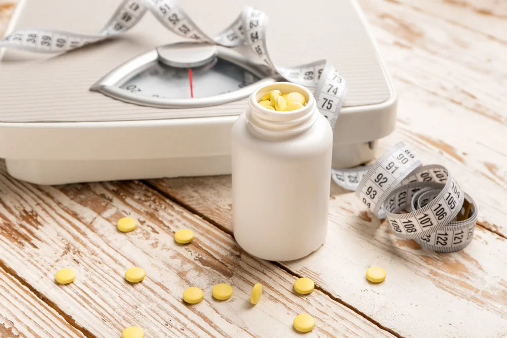 Bathroom scale with a supplement bottle and a measuring tape