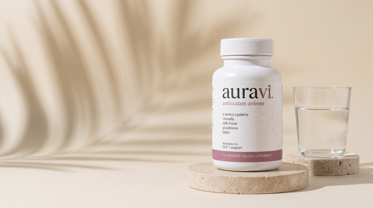 Antioxidant Defense on a travertine plinth with a glass of water
