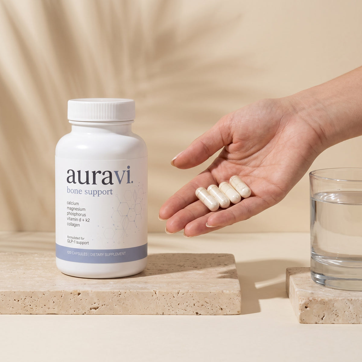 Four Bone Support capsules in hand beside the bottle
