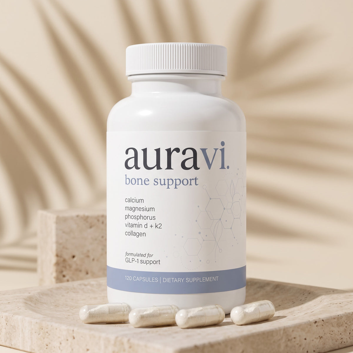 Bone Support capsules on a travertine dish beside the bottle