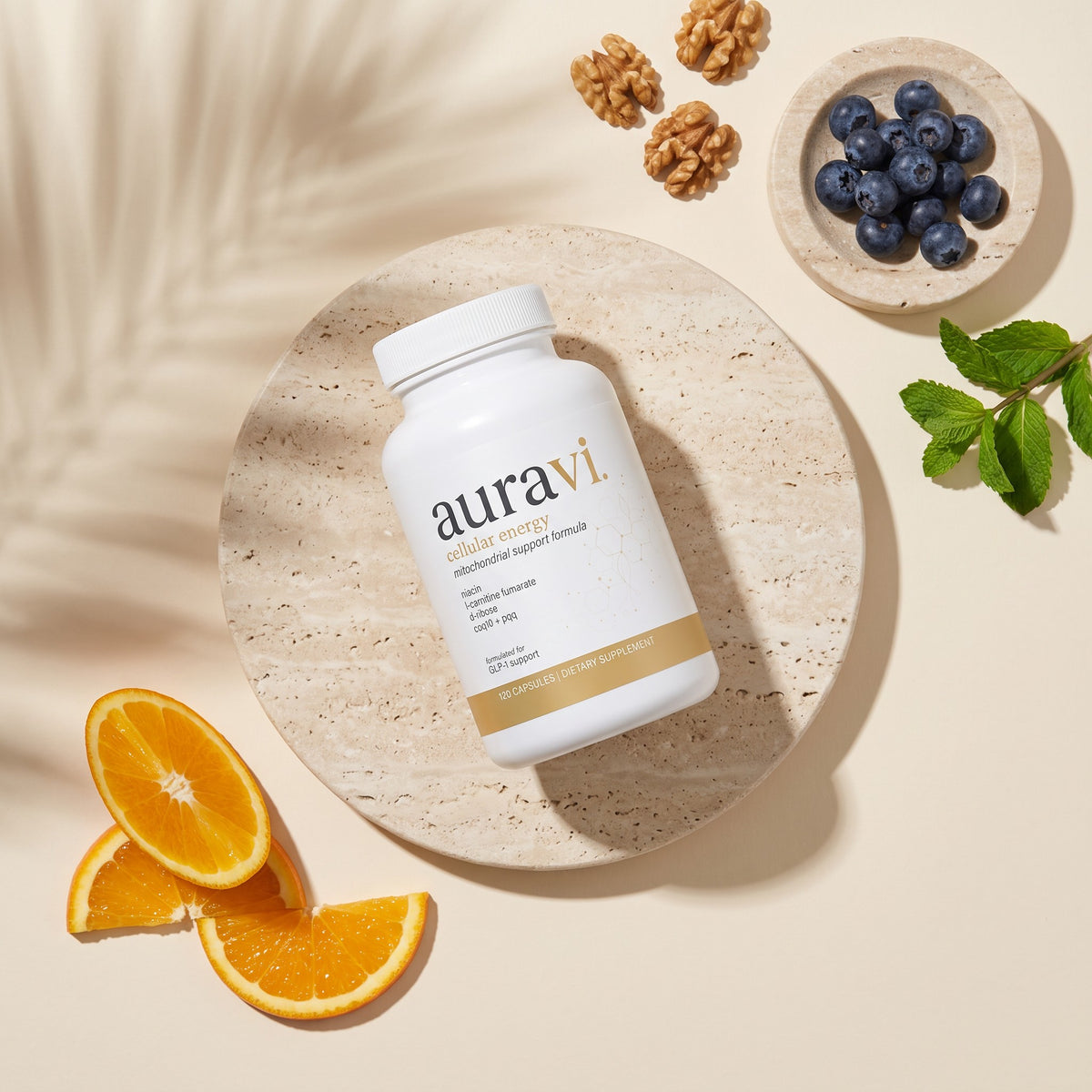 Cellular Energy flat-lay with fresh ingredients on travertine