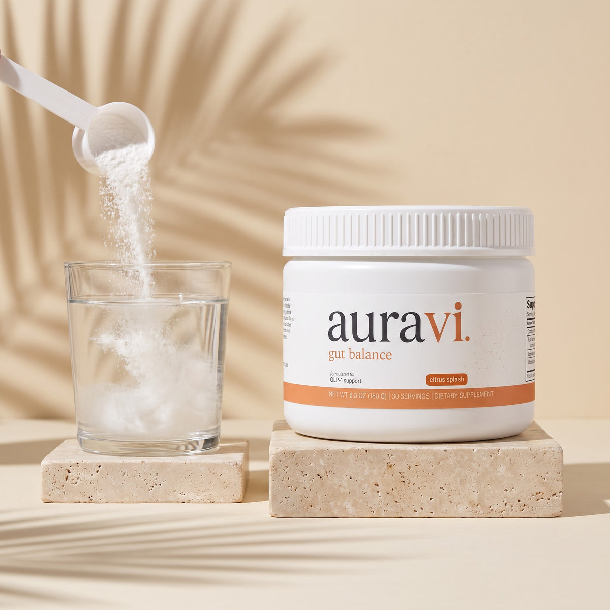 Scoop of Gut Balance powder poured into a glass of water