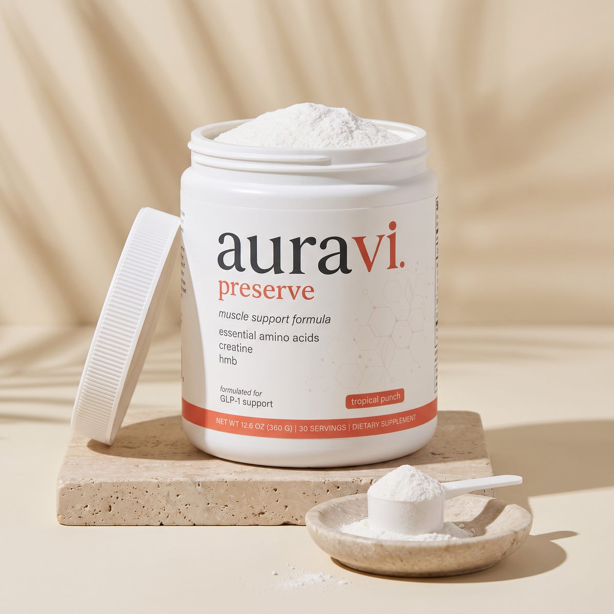 Open tub of Preserve with a scoop of white powder on travertine
